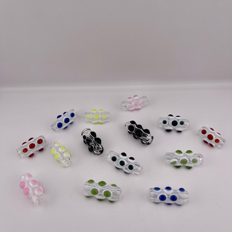 Clear Glass Barrel Bead with Colored glass marbles over white