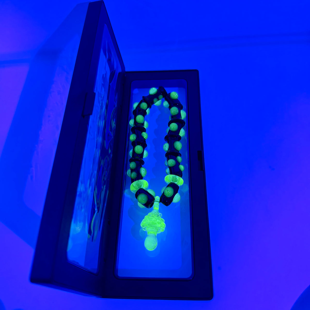 Stretchy Black Glass Bracelet with Green dots that Glow Bright Under Black Light - JeffBeckerGlass.com