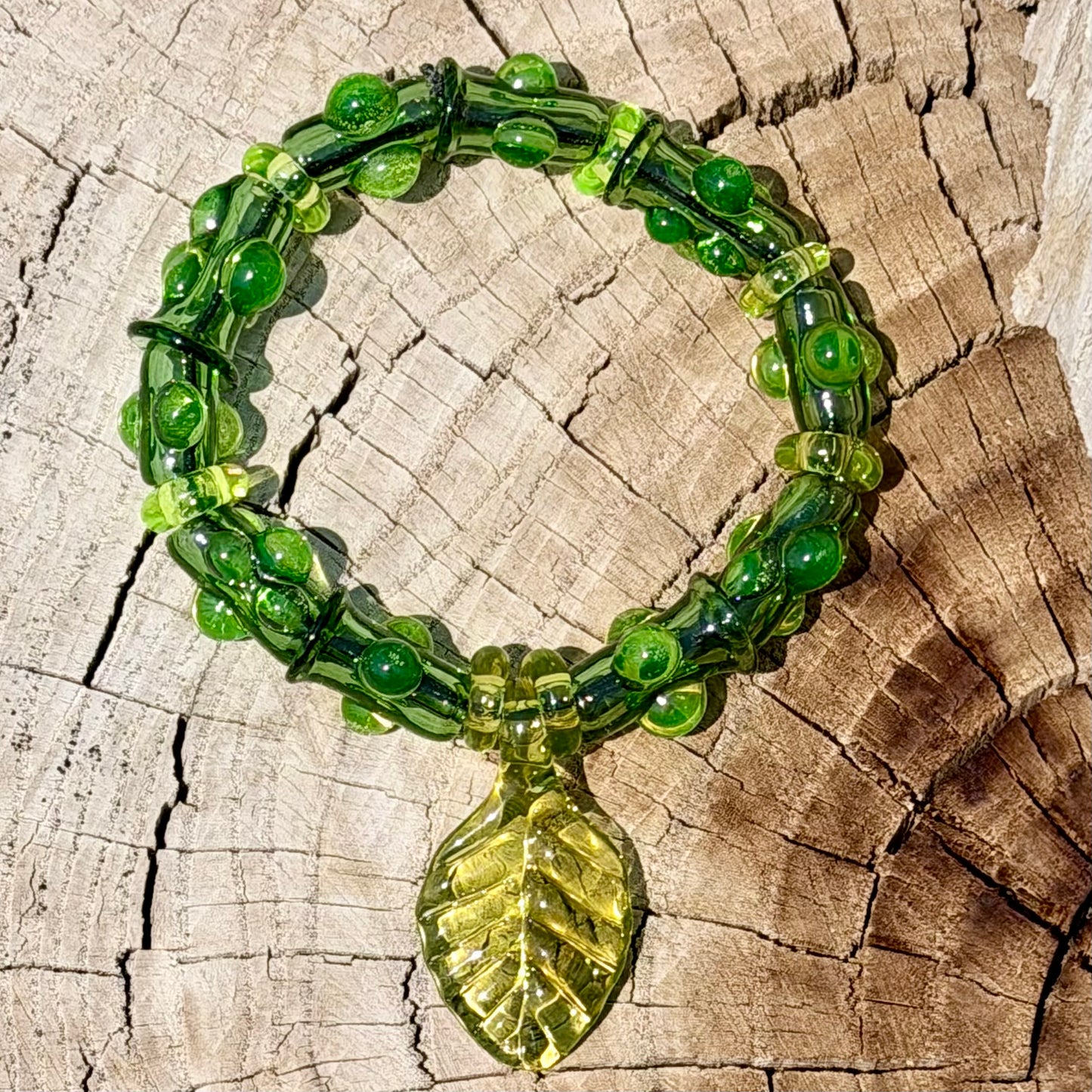 Stretchy  Green Glass Bracelet with leaf and dots that Glow Bright Green Under Black Light