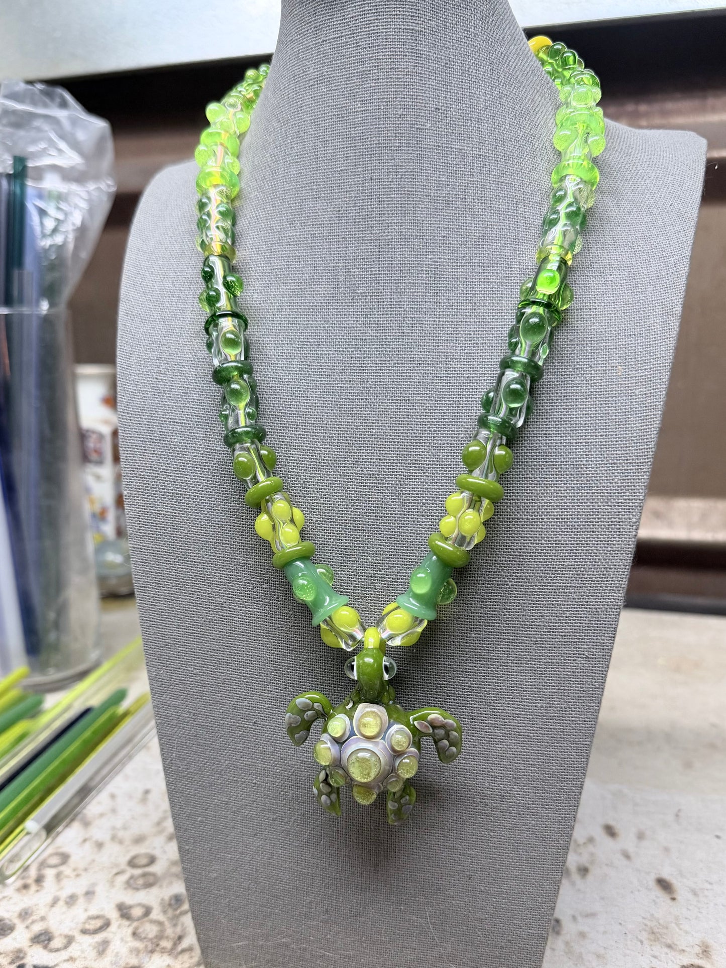 Stretchy Jade Green Glass Necklace with Turtle and dots that Glow Bright Green Under Black Light