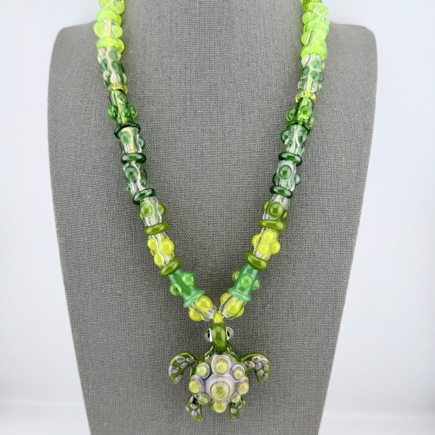 Stretchy Jade Green Glass Necklace with Turtle and dots that Glow Bright Green Under Black Light