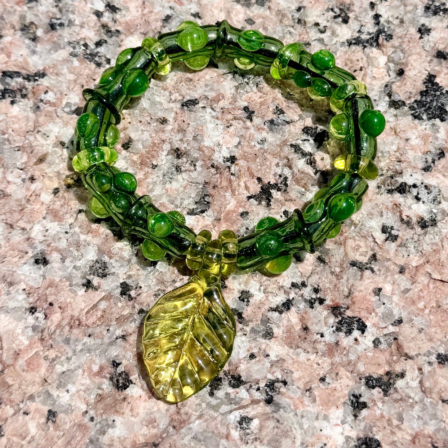 Stretchy  Green Glass Bracelet with leaf and dots that Glow Bright Green Under Black Light