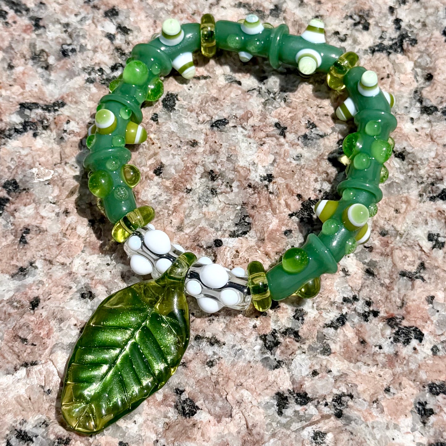 Stretchy Jade Green Glass Bracelet with leaf and dots that Glow Bright Green Under Black Light