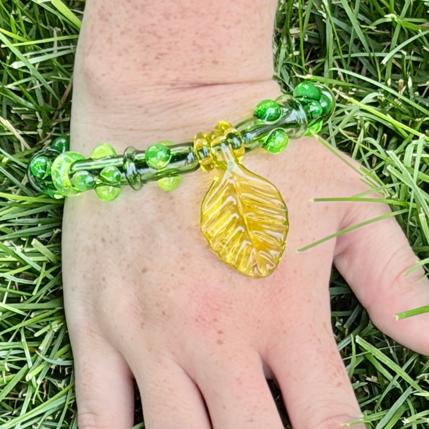 Stretchy  Green Glass Bracelet with leaf and dots that Glow Bright Green Under Black Light