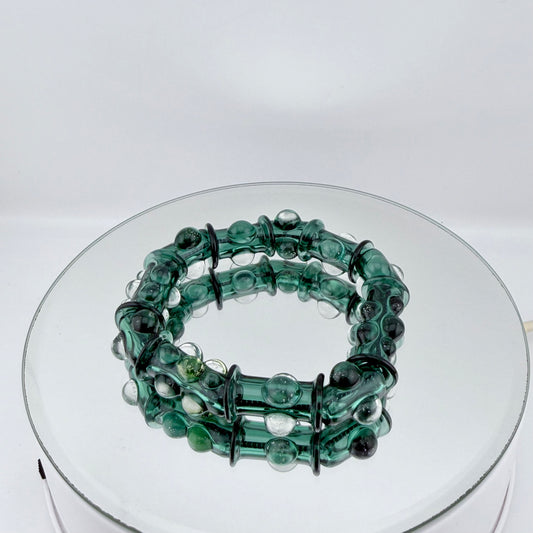 Stretchy Blue Green Glass Bracelet with dots that Glow Bright Pink Under Black Light - JeffBeckerGlass.com