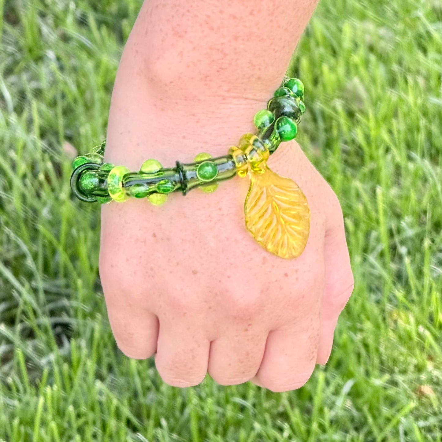 Stretchy  Green Glass Bracelet with leaf and dots that Glow Bright Green Under Black Light