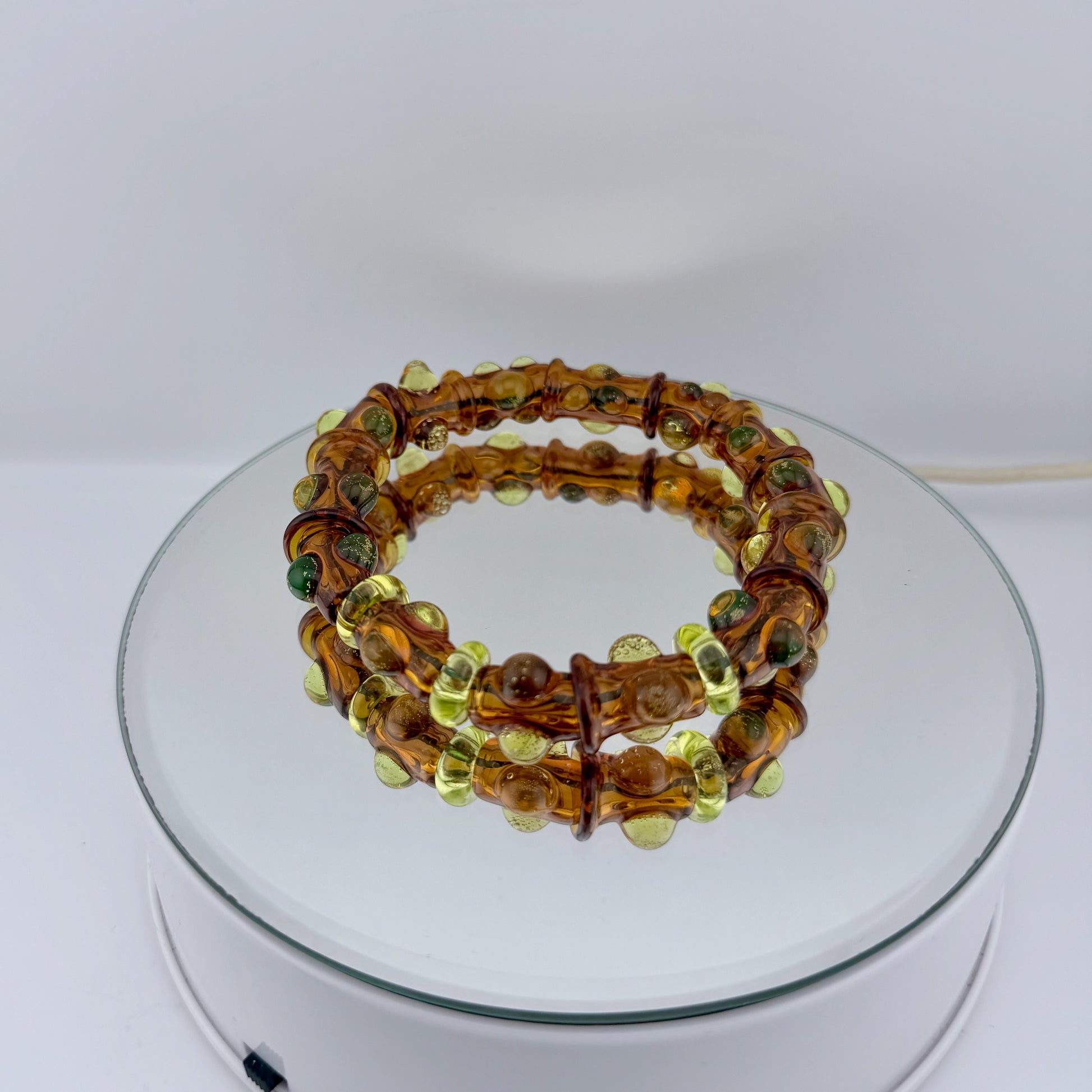 Stretchy Amber Glass Bracelet with dots that Glow Bright Green Under Black Light - JeffBeckerGlass.com