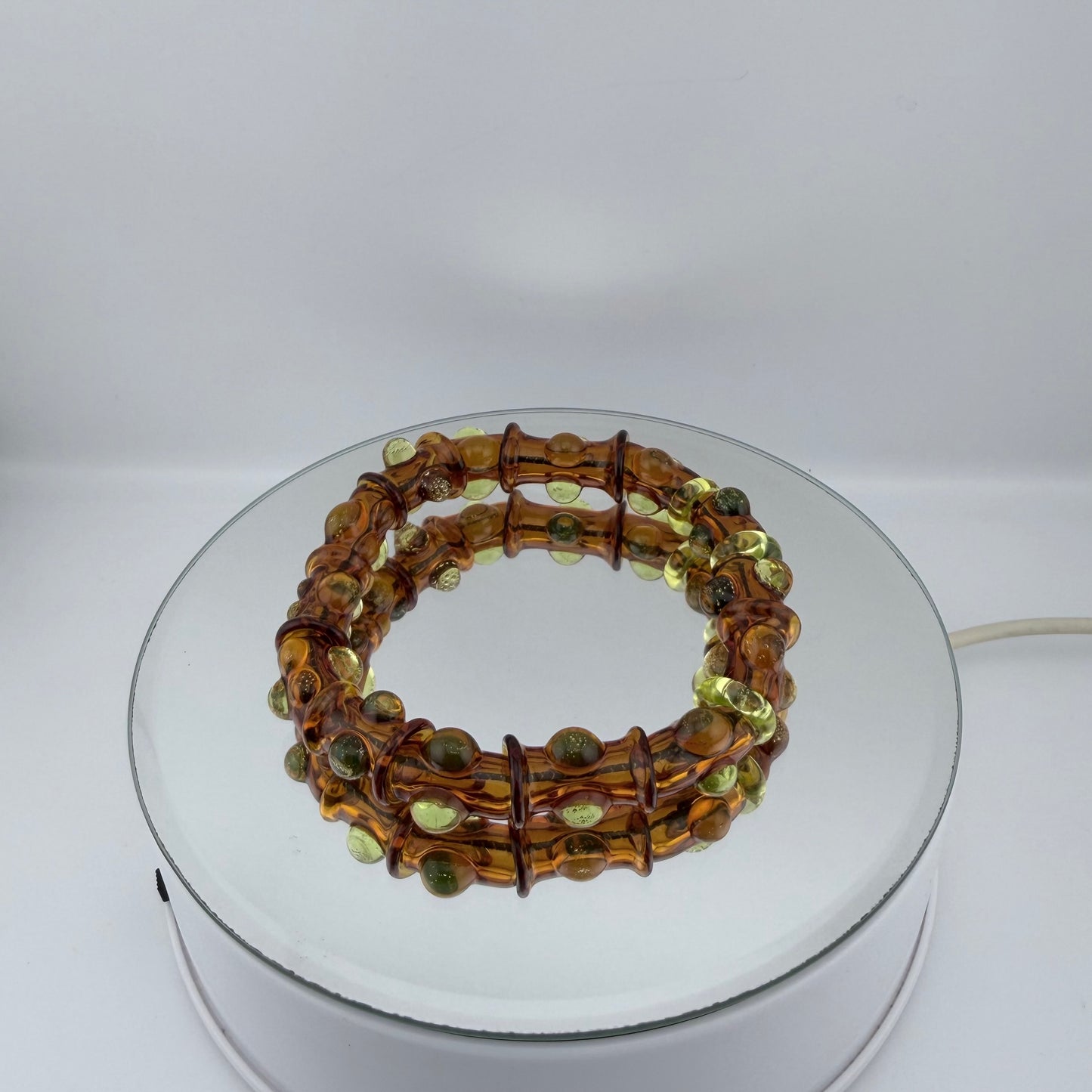 Stretchy Amber Glass Bracelet with dots that Glow Bright Green Under Black Light - JeffBeckerGlass.com