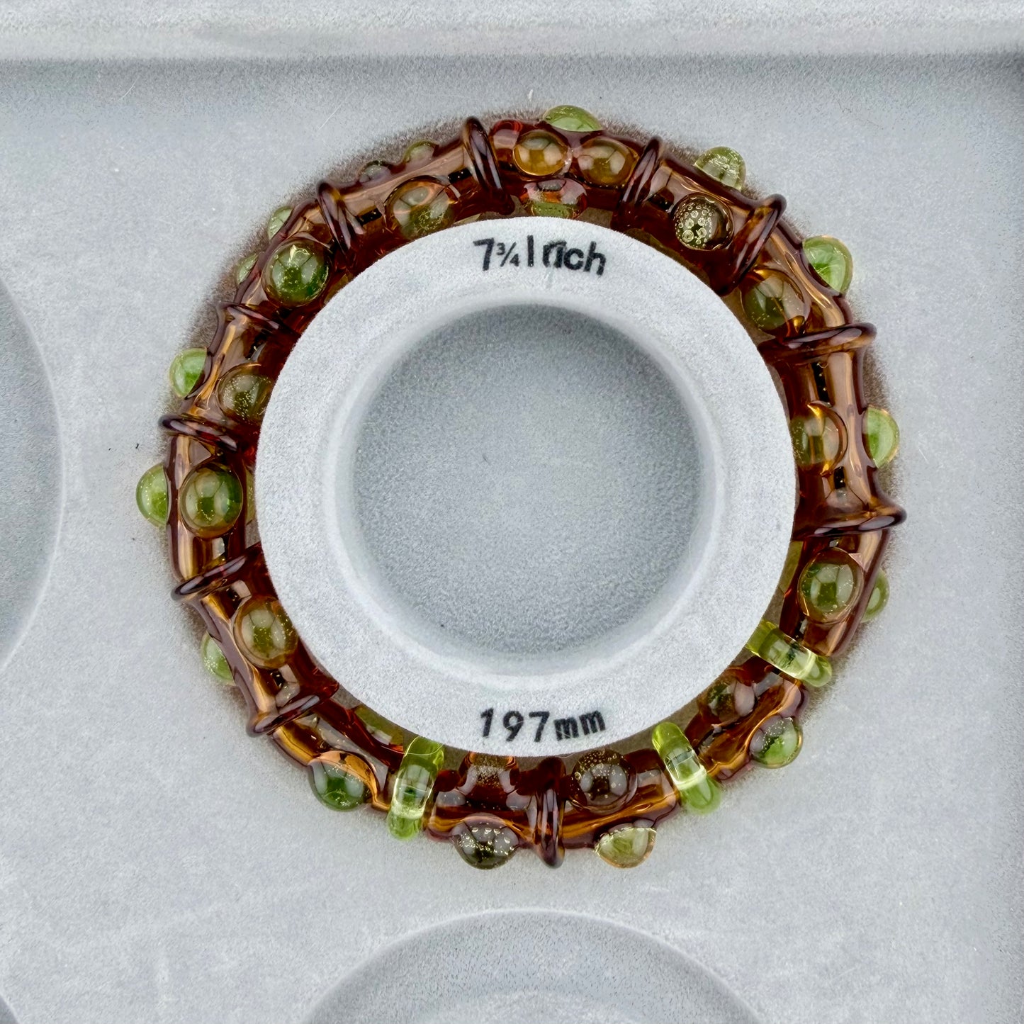 Stretchy Amber Glass Bracelet with dots that Glow Bright Green Under Black Light - JeffBeckerGlass.com