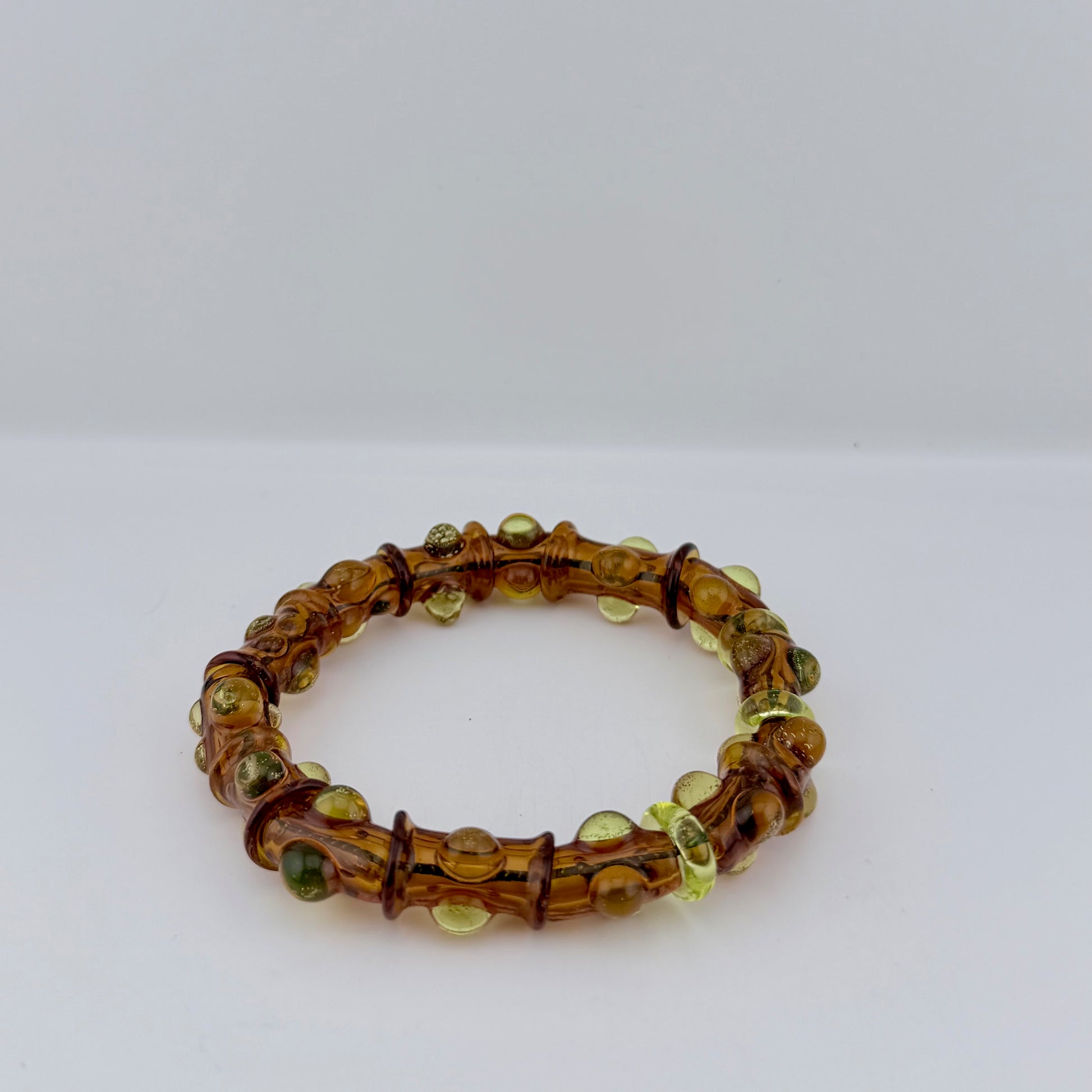Stretchy Amber Glass Bracelet with dots that Glow Bright Green Under Black Light - JeffBeckerGlass.com