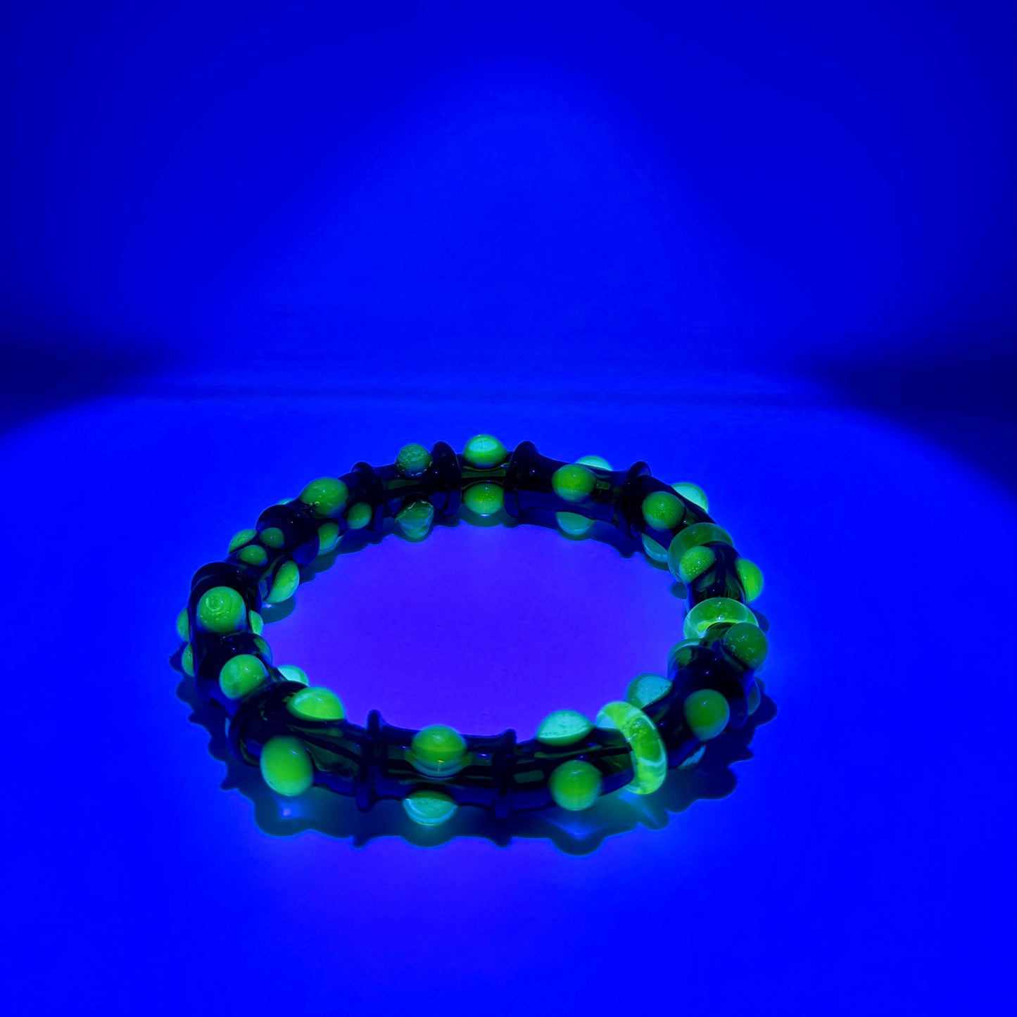 Stretchy Amber Glass Bracelet with dots that Glow Bright Green Under Black Light - JeffBeckerGlass.com