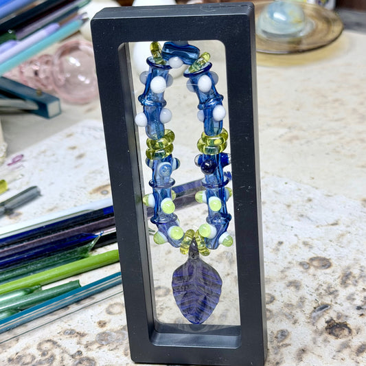 Stretchy Blue Glass Bracelet with dots that Glow Bright Under Black Light and Blue Leaf Pendant