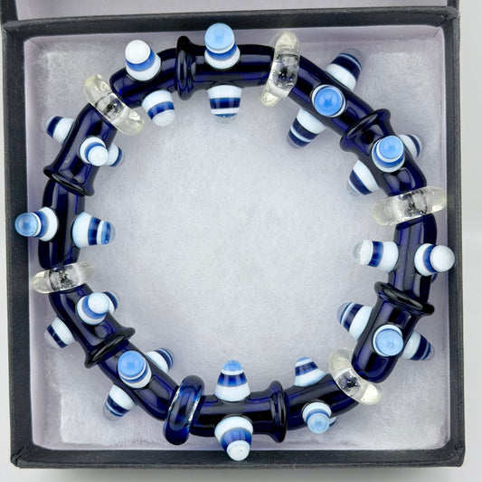 Stretchy Blue Glass Bracelet with Dots that Glow Bright Blue Under Black Light. - JeffBeckerGlass.com