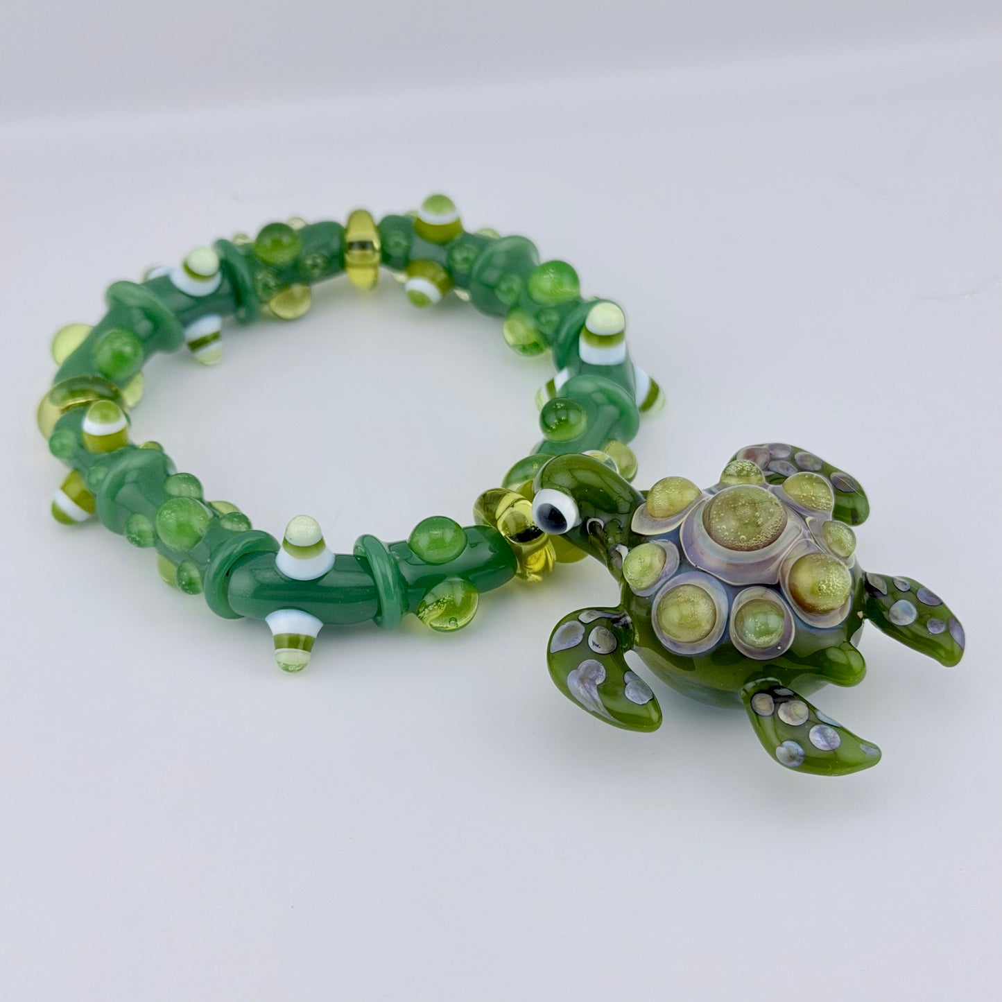 Stretchy Jade Green Glass Bracelet with Turtle and dots that Glow Bright Green Under Black Light