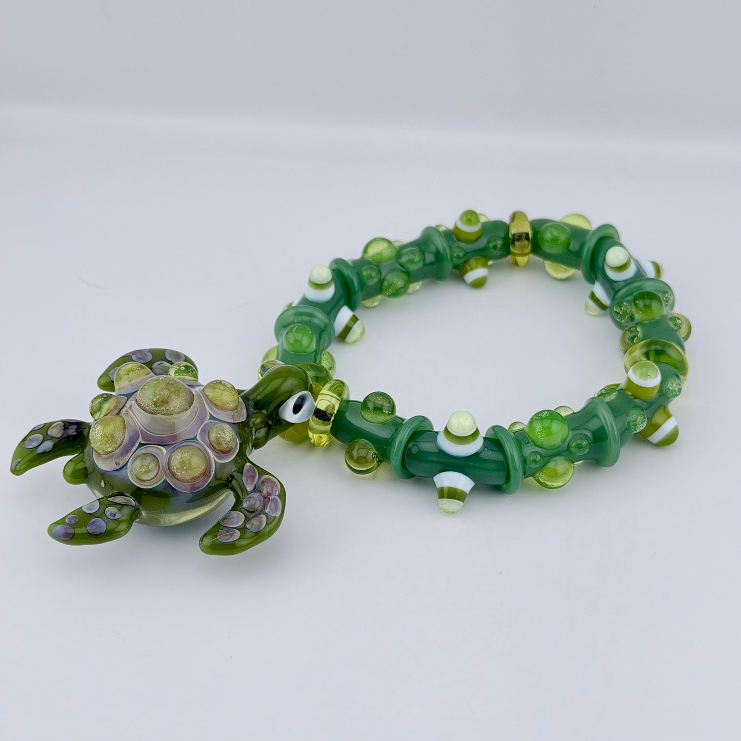Stretchy Jade Green Glass Bracelet with Turtle and dots that Glow Bright Green Under Black Light