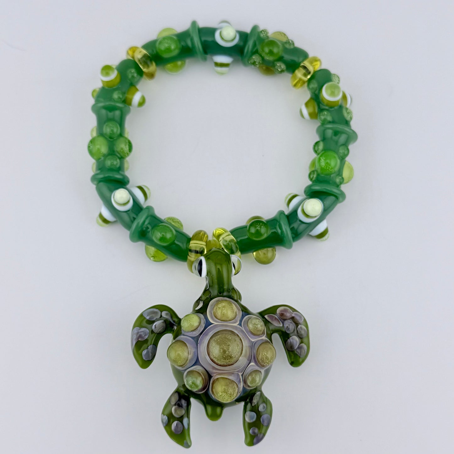 Stretchy Jade Green Glass Bracelet with Turtle and dots that Glow Bright Green Under Black Light