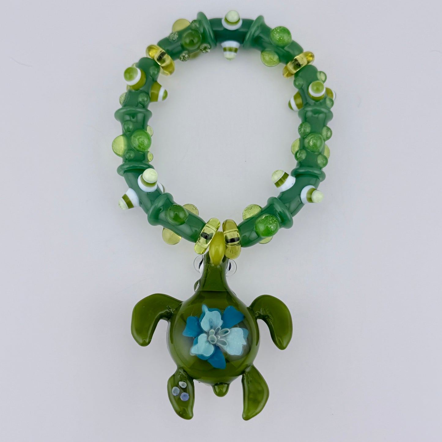Stretchy Jade Green Glass Bracelet with Turtle and dots that Glow Bright Green Under Black Light