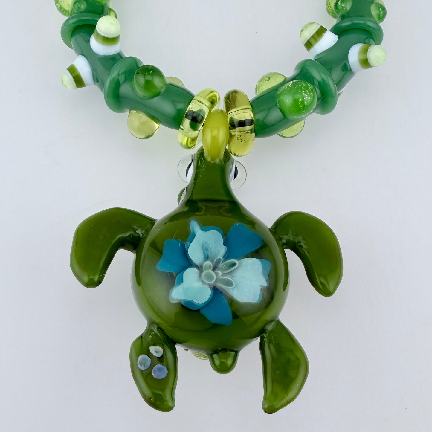 Stretchy Jade Green Glass Bracelet with Turtle and dots that Glow Bright Green Under Black Light