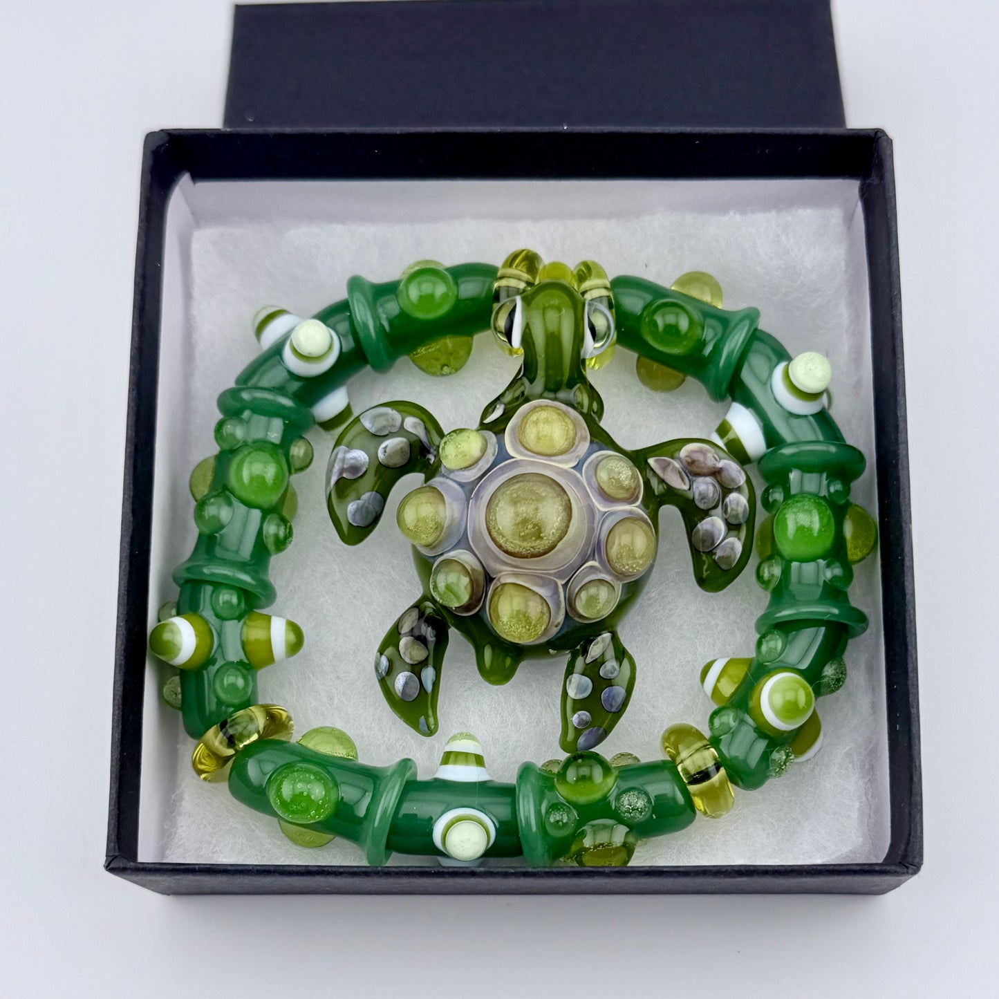 Stretchy Jade Green Glass Bracelet with Turtle and dots that Glow Bright Green Under Black Light