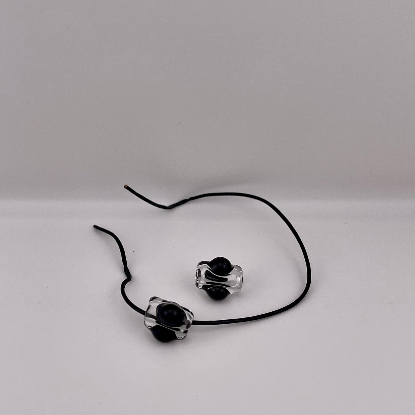 2 Clear beads with Black marbles